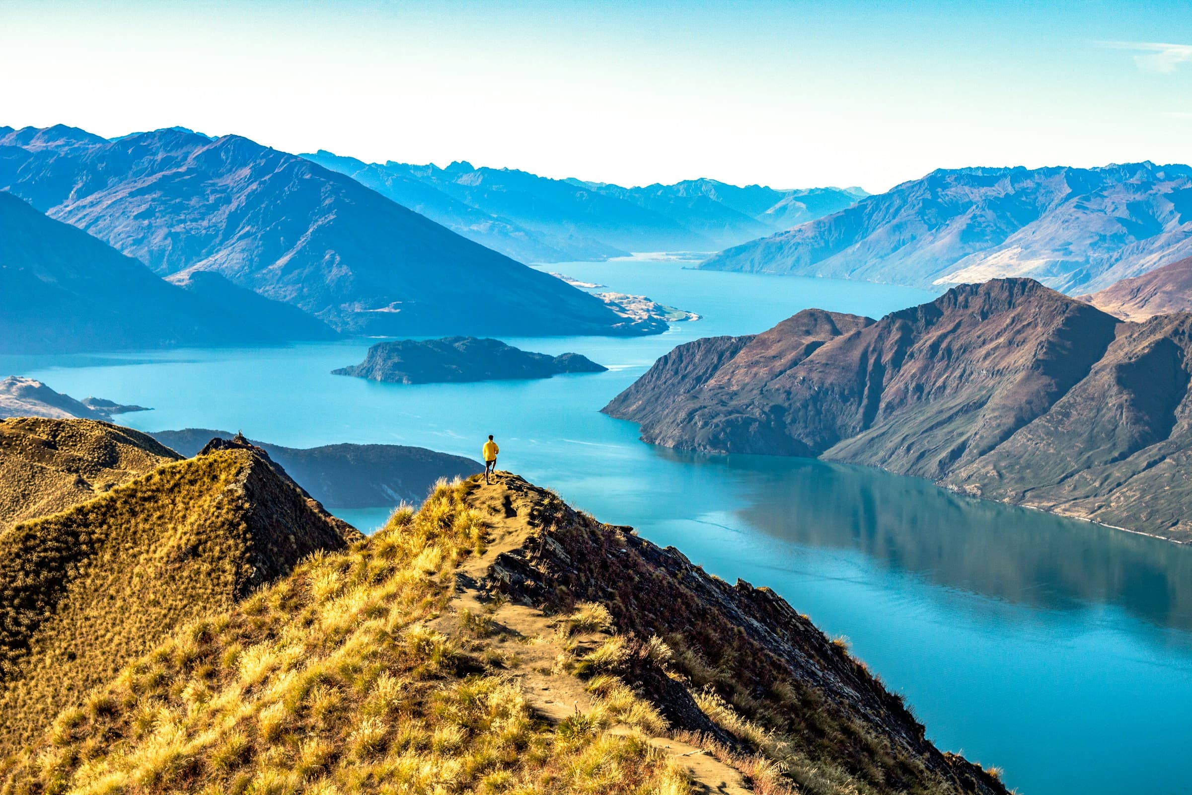 Roys Peak ridge overlooking the mountains and blue waters of Lake Wānaka, New Zealand